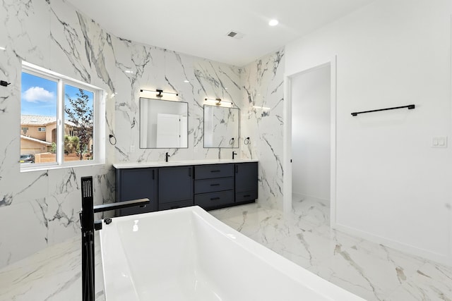 5624 Laredo, Rio Rancho, NM 87144 - full bathroom featuring a soaking tub, marble tiled floors, double vanity, and stone wall