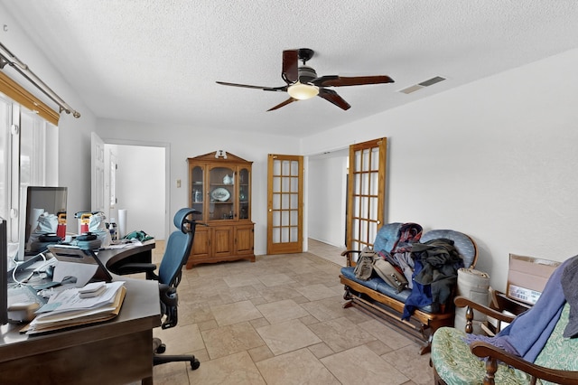 855 Foxcroft Loop, Bosque Farms, NM 87068 - office area featuring a ceiling fan, a textured ceiling, light stone finish flooring, and french doors