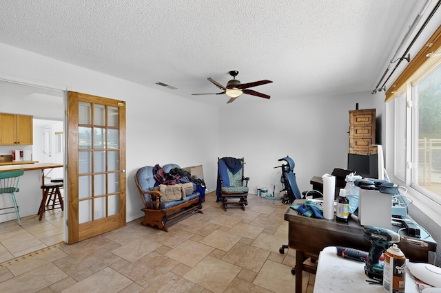 855 Foxcroft Loop, Bosque Farms, NM 87068 - office area featuring ceiling fan, a textured ceiling, and light stone finish floors
