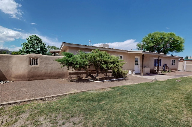 855 Foxcroft Loop, Bosque Farms, NM 87068 - rear view of property featuring stucco siding and a patio area