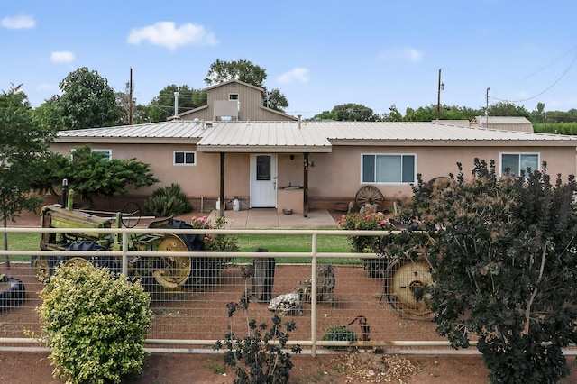 855 Foxcroft Loop, Bosque Farms, NM 87068 - view of front of property featuring stucco siding, a metal roof, and a patio