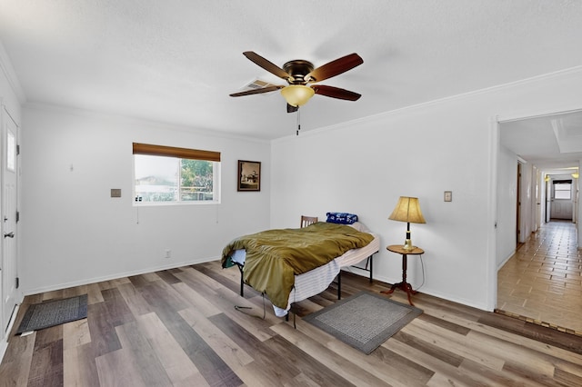 855 Foxcroft Loop, Bosque Farms, NM 87068 - bedroom featuring crown molding, wood finished floors, and a ceiling fan