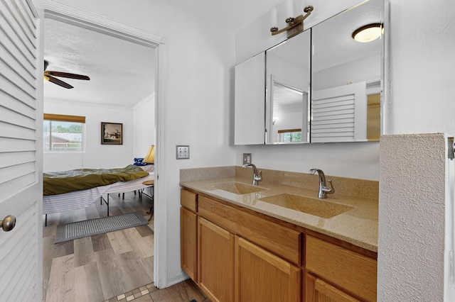 855 Foxcroft Loop, Bosque Farms, NM 87068 - ensuite bathroom with double vanity, a ceiling fan, wood finished floors, and crown molding