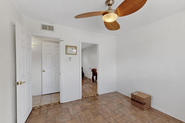 855 Foxcroft Loop, Bosque Farms, NM 87068 - unfurnished room with a ceiling fan, stone finish floors, and a textured ceiling