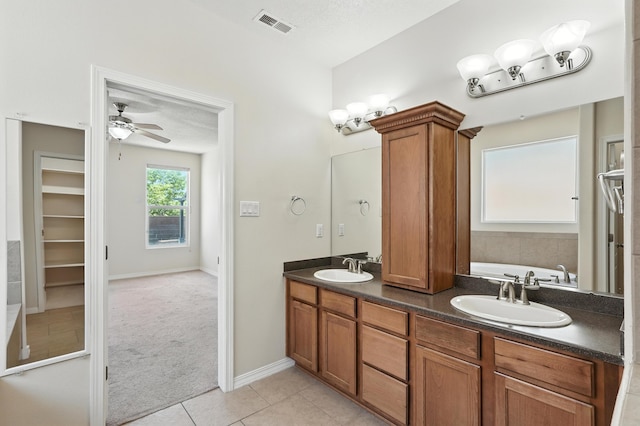 6903 Wrangell Loop NE, Rio Rancho, NM 87144 - full bath featuring tile patterned flooring, a bath, double vanity, and ceiling fan