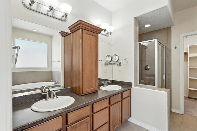 6903 Wrangell Loop NE, Rio Rancho, NM 87144 - full bath featuring a shower stall, tile patterned flooring, a bath, double vanity, and a walk in closet