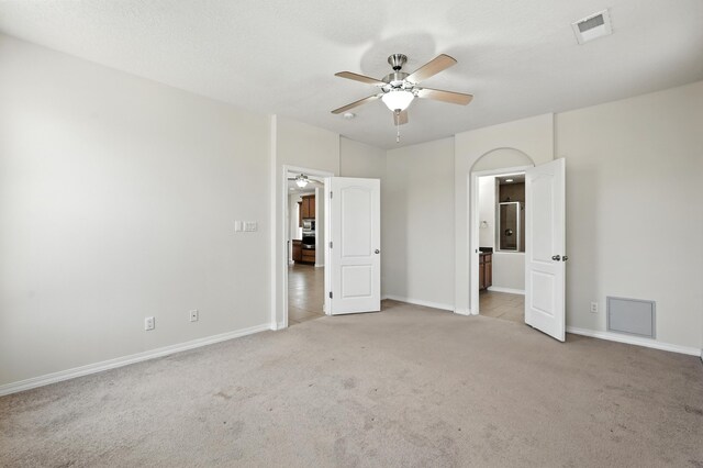 6903 Wrangell Loop NE, Rio Rancho, NM 87144 - unfurnished bedroom with light carpet, ceiling fan, and connected bathroom