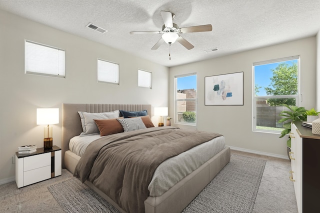 6903 Wrangell Loop NE, Rio Rancho, NM 87144 - bedroom with light colored carpet, a textured ceiling, and a ceiling fan