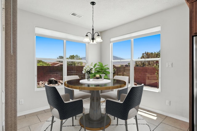 6903 Wrangell Loop NE, Rio Rancho, NM 87144 - dining space featuring light tile patterned floors and a chandelier