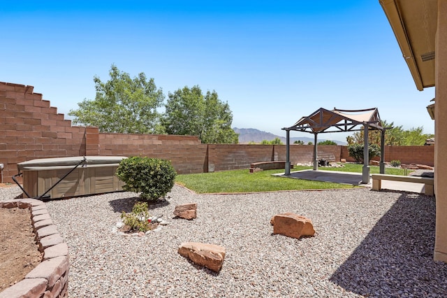 6903 Wrangell Loop NE, Rio Rancho, NM 87144 - fenced backyard featuring a hot tub, a gazebo, a patio, and a mountain view