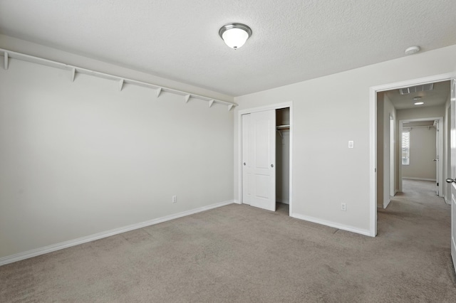 6903 Wrangell Loop NE, Rio Rancho, NM 87144 - unfurnished bedroom featuring carpet flooring, a closet, and a textured ceiling