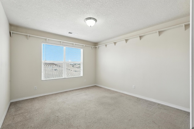 6903 Wrangell Loop NE, Rio Rancho, NM 87144 - empty room featuring light carpet and a textured ceiling