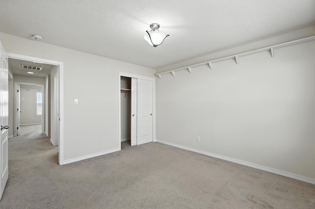6903 Wrangell Loop NE, Rio Rancho, NM 87144 - unfurnished bedroom featuring light colored carpet, a closet, and a textured ceiling