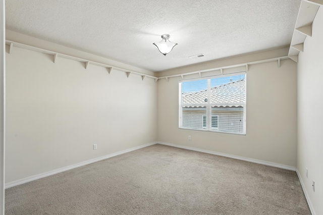 6903 Wrangell Loop NE, Rio Rancho, NM 87144 - spare room with light carpet and a textured ceiling