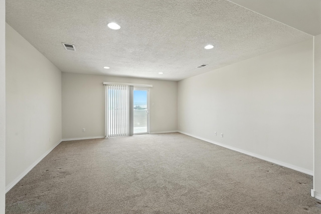 6903 Wrangell Loop NE, Rio Rancho, NM 87144 - spare room featuring carpet flooring, a textured ceiling, and recessed lighting