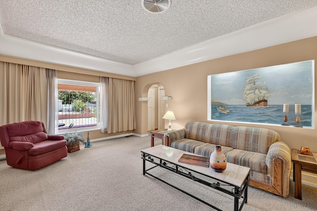 302 Crestview Dr SW, Albuquerque, NM 87105 - living room with arched walkways, light carpet, and a textured ceiling