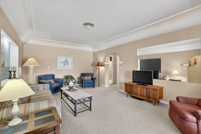 302 Crestview Dr SW, Albuquerque, NM 87105 - living area featuring a textured ceiling, arched walkways, and carpet floors