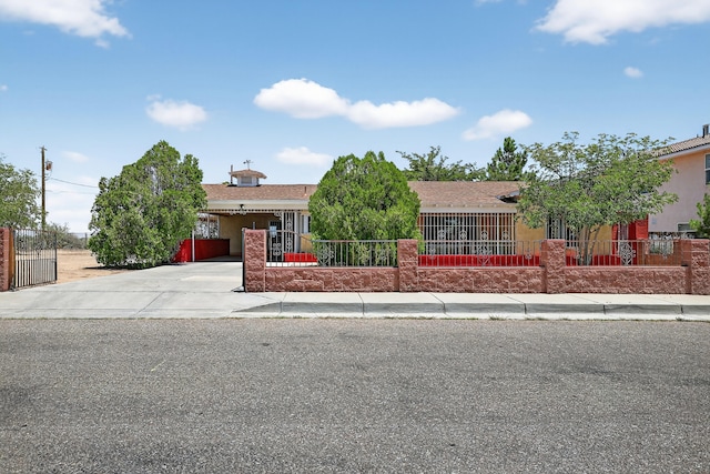 302 Crestview Dr SW, Albuquerque, NM 87105 - view of front facade with a fenced front yard, concrete driveway, and stucco siding