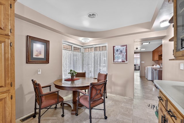 302 Crestview Dr SW, Albuquerque, NM 87105 - dining area with separate washer and dryer and baseboards