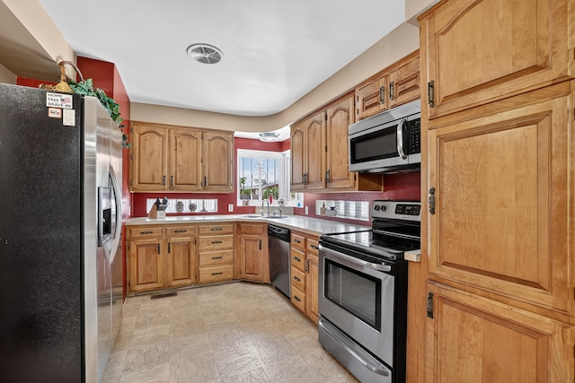 302 Crestview Dr SW, Albuquerque, NM 87105 - kitchen with appliances with stainless steel finishes, light countertops, and brown cabinets