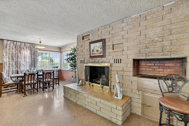 302 Crestview Dr SW, Albuquerque, NM 87105 - living room featuring a textured ceiling, a brick fireplace, and speckled floor