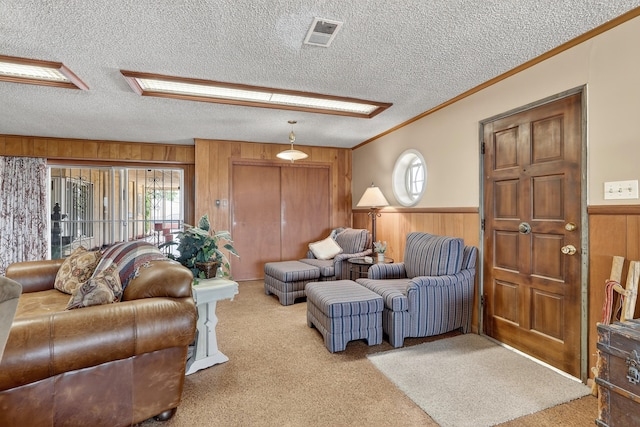 302 Crestview Dr SW, Albuquerque, NM 87105 - carpeted living room with wooden walls, crown molding, a textured ceiling, a wainscoted wall, and plenty of natural light