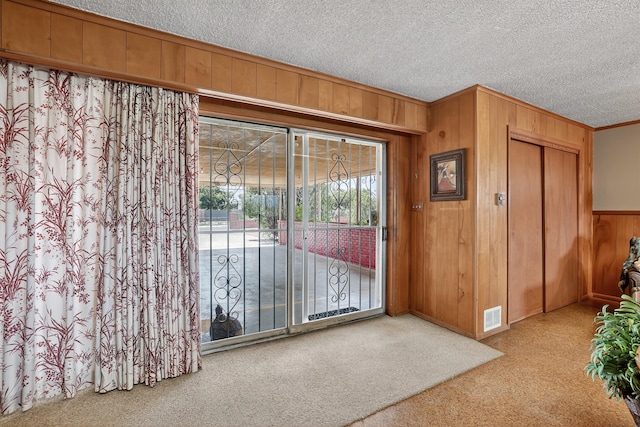302 Crestview Dr SW, Albuquerque, NM 87105 - foyer entrance featuring wood walls, carpet, crown molding, and a textured ceiling