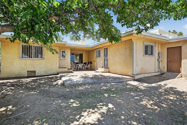 302 Crestview Dr SW, Albuquerque, NM 87105 - rear view of house featuring a patio, stucco siding, and entry steps