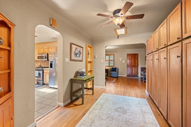 704 Tyler Rd NW, Los Ranchos, NM 87107 - hallway featuring arched walkways and light wood-style flooring