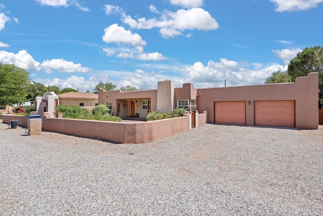 704 Tyler Rd NW, Los Ranchos, NM 87107 - southwest-style home featuring stucco siding, a garage, and driveway