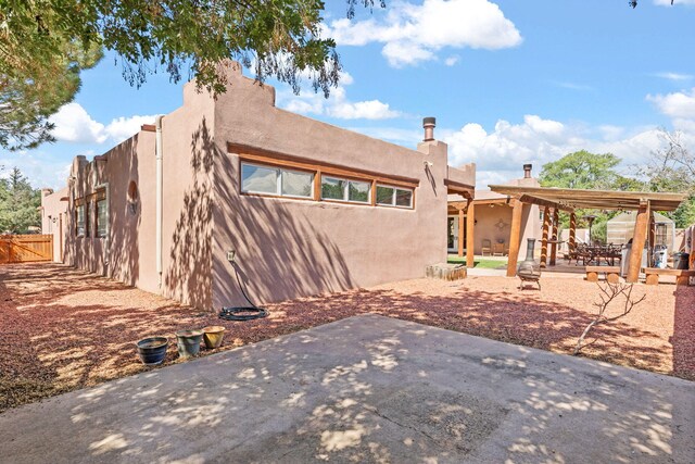 704 Tyler Rd NW, Los Ranchos, NM 87107 - rear view of house featuring a patio area and stucco siding