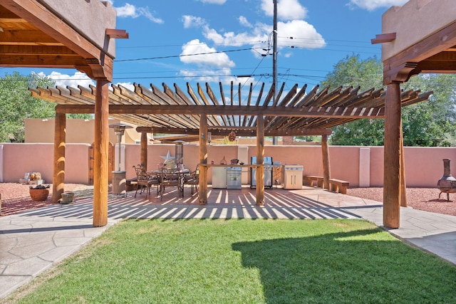 704 Tyler Rd NW, Los Ranchos, NM 87107 - view of yard featuring a pergola, a patio area, and an outdoor kitchen