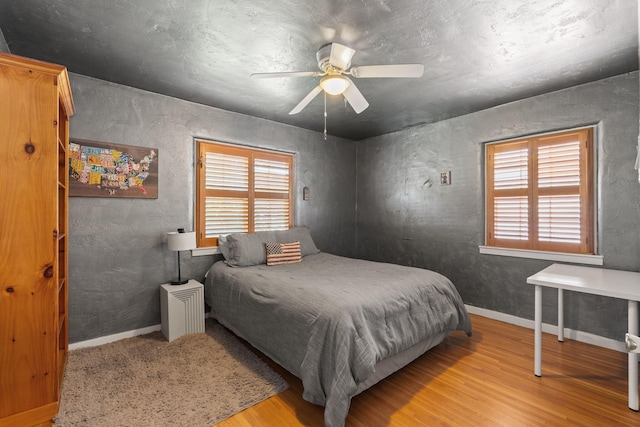 704 Tyler Rd NW, Los Ranchos, NM 87107 - bedroom featuring wood finished floors and a ceiling fan