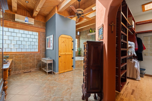 704 Tyler Rd NW, Los Ranchos, NM 87107 - interior space with a wooden ceiling with exposed beams, tiled tub, an AC wall unit, a ceiling fan, and a shower