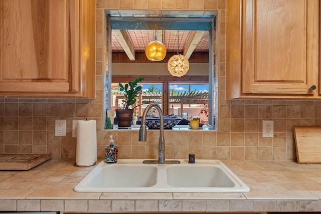 704 Tyler Rd NW, Los Ranchos, NM 87107 - kitchen view of tile counters, decorative backsplash, and light brown cabinetry