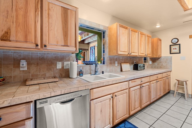 704 Tyler Rd NW, Los Ranchos, NM 87107 - kitchen featuring stainless steel dishwasher, light brown cabinets, light tile patterned floors, and tasteful backsplash