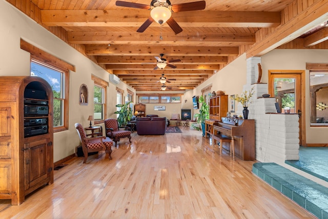 704 Tyler Rd NW, Los Ranchos, NM 87107 - living room with ceiling fan, light wood finished floors, a wall mounted AC, and a wood ceiling with exposed beams