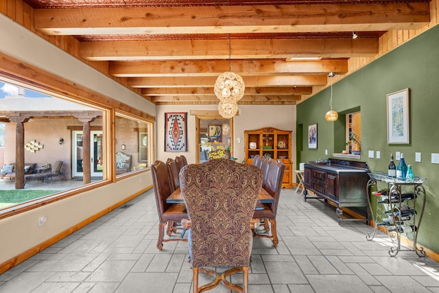 704 Tyler Rd NW, Los Ranchos, NM 87107 - dining area featuring beamed ceiling, a chandelier, and stone tile floors