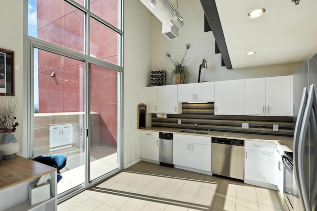 524 Central Ave SW # 803, Albuquerque, NM 87102 - kitchen featuring dishwasher, light tile patterned floors, decorative backsplash, stove, and white cabinets