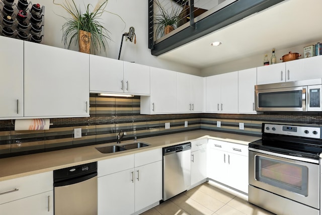 524 Central Ave SW # 803, Albuquerque, NM 87102 - kitchen featuring appliances with stainless steel finishes, backsplash, light countertops, white cabinetry, and recessed lighting
