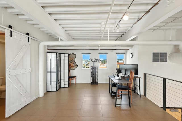 524 Central Ave SW # 803, Albuquerque, NM 87102 - tiled home office with a barn door and track lighting