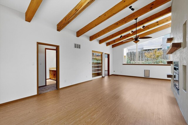 1865 Tramway Terrace Loop NE, Albuquerque, NM 87122 - unfurnished living room with a fireplace, a ceiling fan, beam ceiling, and wood finished floors