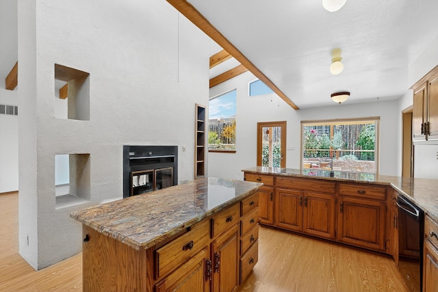 1865 Tramway Terrace Loop NE, Albuquerque, NM 87122 - kitchen featuring light wood-style floors, black dishwasher, brown cabinetry, stone countertops, and beamed ceiling