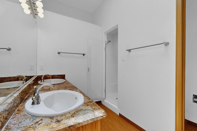 1865 Tramway Terrace Loop NE, Albuquerque, NM 87122 - bathroom with double vanity, a shower stall, and wood finished floors