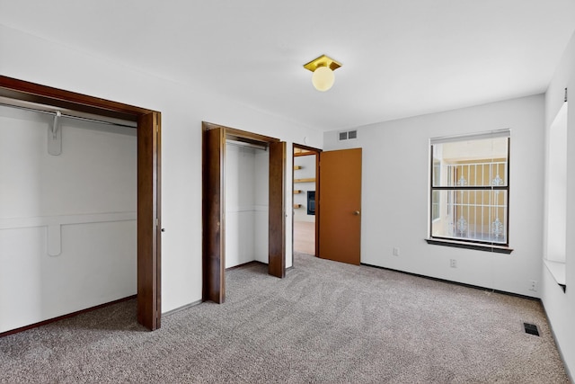 1865 Tramway Terrace Loop NE, Albuquerque, NM 87122 - unfurnished bedroom with carpet flooring and multiple closets