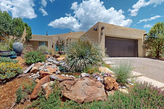 1865 Tramway Terrace Loop NE, Albuquerque, NM 87122 - pueblo revival-style home featuring a garage, driveway, and stucco siding