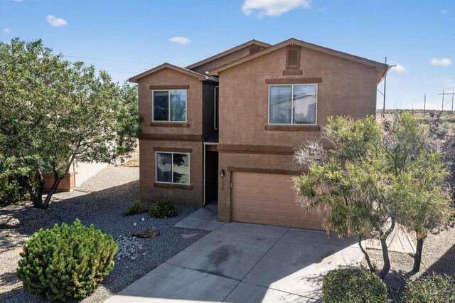 1324 Desert Paintbrush Loop, Rio Rancho, NM 87144 - view of front of property with stucco siding, driveway, and a garage