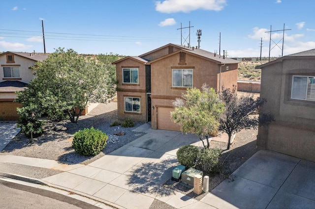1324 Desert Paintbrush Loop, Rio Rancho, NM 87144 - view of front of house with stucco siding, driveway, and a garage