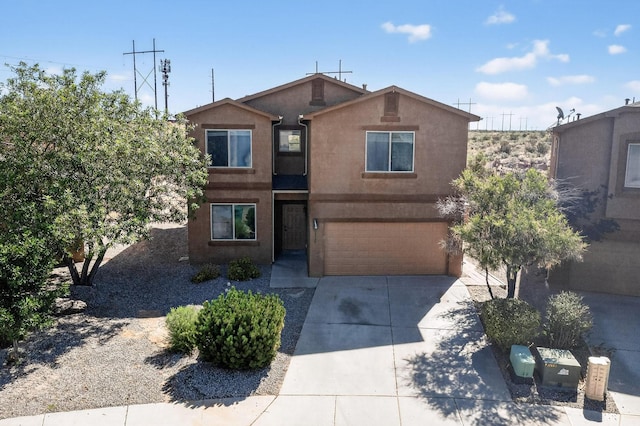 1324 Desert Paintbrush Loop, Rio Rancho, NM 87144 - view of front of house with an attached garage, driveway, and stucco siding