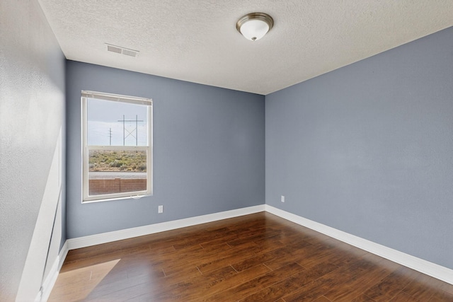 1324 Desert Paintbrush Loop, Rio Rancho, NM 87144 - spare room featuring dark wood-type flooring and a textured ceiling
